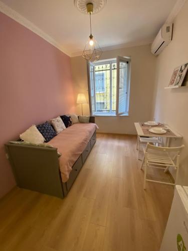 a bedroom with a bed and a table and a window at Sapphire Suites Taksim in Istanbul