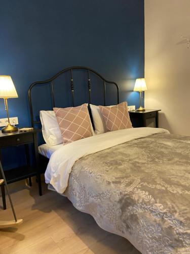 a bedroom with a bed with pillows and two lamps at Sapphire Suites Taksim in Istanbul