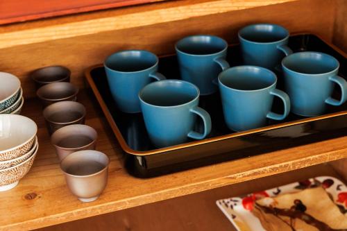 a tray of blue cups sitting on a shelf at 彦宿Hikojyuku戸建て貸切宿 in Hikone
