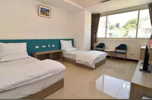 Postel nebo postele na pokoji v ubytování Xiangbin B&B