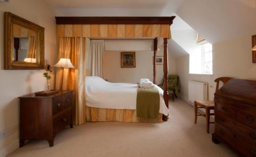 En eller flere senge i et værelse på Newmarket Cottage