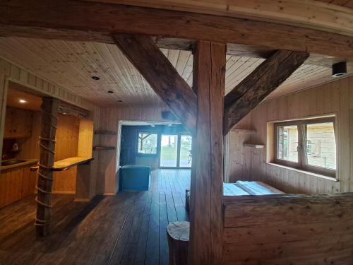 a large room with wooden floors and a wooden ceiling at Siedlisko nad Jeziorem-Mazury in Mrągowo