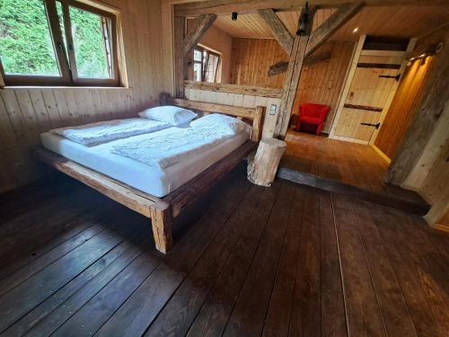 a bedroom with a bed in a wooden room at Siedlisko nad Jeziorem-Mazury in Mrągowo