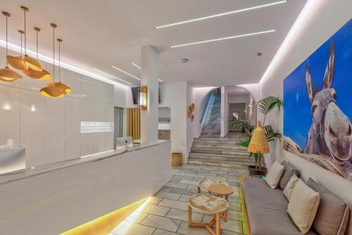 a living room with a couch and a wall with a mural at Golden Beach Hotel in Chrissi Akti