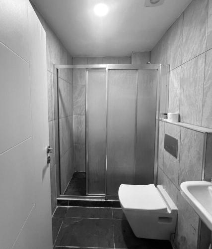 a bathroom with a shower and a toilet and a sink at Destinia Pera in Istanbul