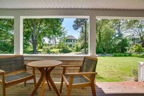 a screened in porch with two chairs and a table at 1 Mi to Beach Cape Cod Family Home in Bourne! in Bourne