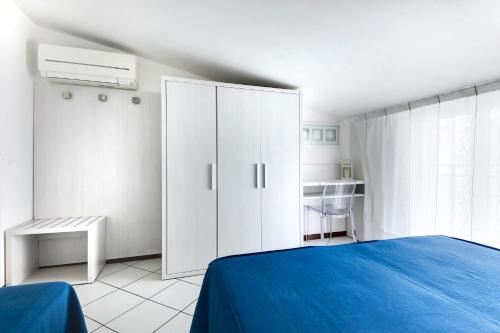 a bedroom with a white cabinet and a blue bed at Residence Diffuso Arcobaleno in Gabicce Mare