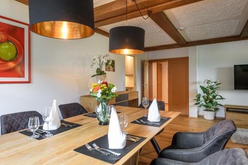 a dining room with a wooden table and chairs at Hotel & Restaurant Wastlwirt in Sankt Michael im Lungau