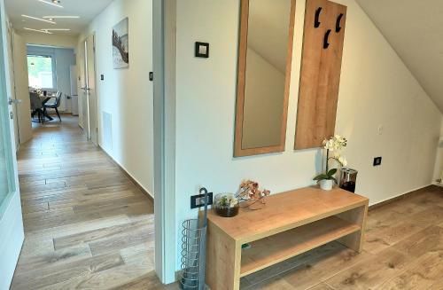 a hallway with a sink and a mirror on a wall at Apartments Lipa Plac in Postojna
