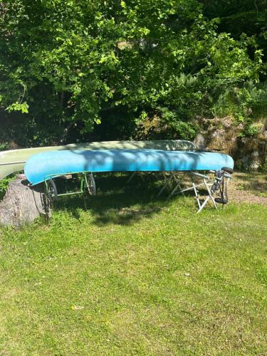 a blue canoe sitting on top of a tree stump at Pool House in Tyresö