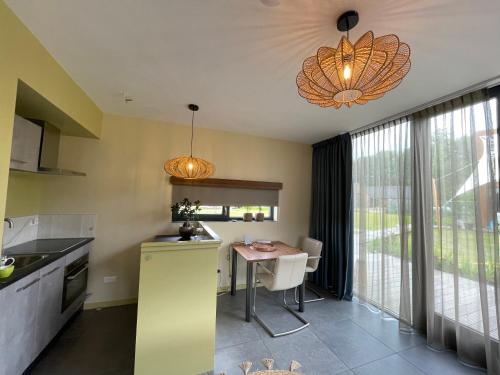 a kitchen with a table and a dining room at Casitas Wijchen - Nijmegen in Wijchen