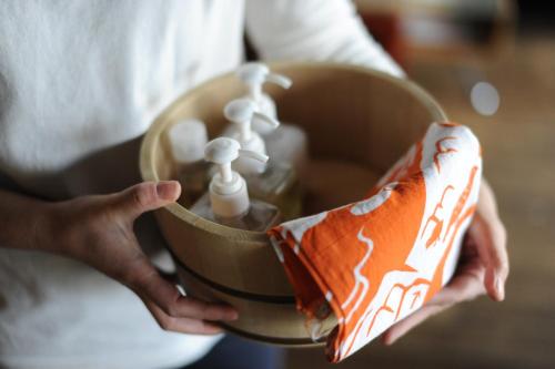 a person holding a container with two toothbrushes at 1166 Backpackers in Nagano
