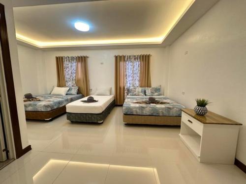 a living room with two beds and a couch at DonRio Hotel Siquijor in Siquijor