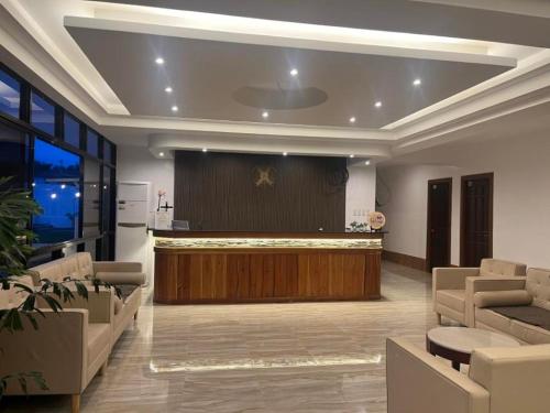 a lobby with a bar and a stage with chairs at DonRio Hotel Siquijor in Siquijor