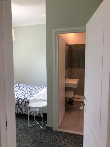 a bedroom with a bed and a sink and a mirror at Il Delfino in Tellaro