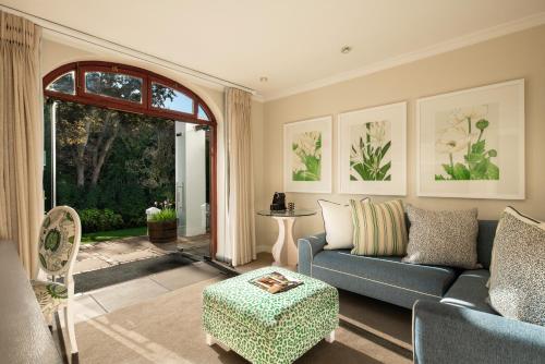 a living room with a couch and a table at The Cellars-Hohenort in Cape Town