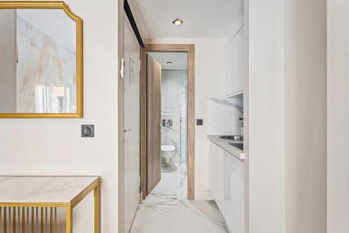 La salle de bains est pourvue d'un sol en marbre et d'un miroir. dans l'établissement Nice Renting - 7FRANCE - Suite Luxe & Confort Bord de Mer Massena, à Nice