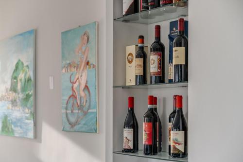 a bunch of bottles of wine sitting on shelves at Hotel Baia Del Capitano in Cefalù