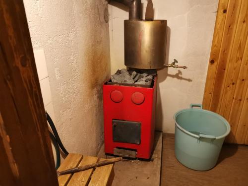 a red stove with a pot on top of it at Linnantie 2 in Mikkeli