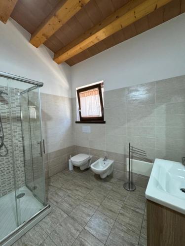 a bathroom with a shower and a toilet and a sink at Antico borgo Rinaldi in Circello