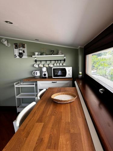 a kitchen with a wooden table and a microwave at Formia Bellevue in Formia
