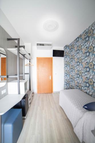 a bedroom with a bed and a wall with a blue pattern at All'Orologio - Boutique Hotel in Caorle
