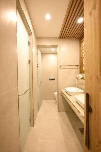 a bathroom with a toilet and a sink and a shower at Hanok Hotel DAAM Seoul in Seoul