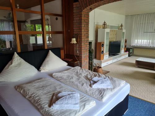 a bedroom with a bed with two towels on it at NordseeResort Hotel & Suite Arche Noah in Horumersiel
