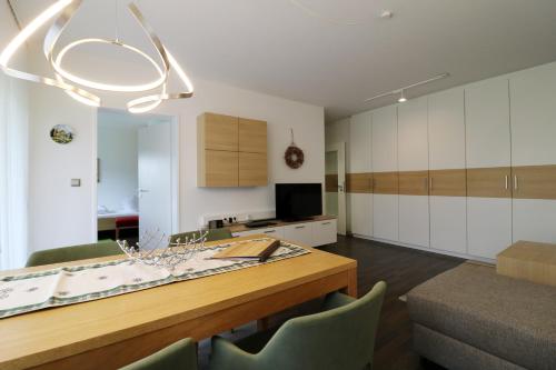 a kitchen with a wooden table and a dining room at Ferienwohnung "Domicil Schluchsee" in Schluchsee