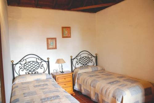 a bedroom with two beds and a table with a lamp at Ferienhaus für 5 Personen ca 65 qm in Breña Alta, La Palma Ostküste von La Palma in Breña Alta