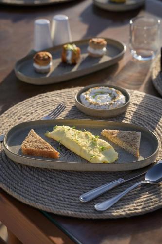 einen Tisch mit Käseplatten und Brot darauf in der Unterkunft The Zen Wellness Resort in Assuan