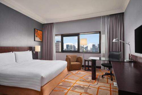 a hotel room with a bed and a desk at Holiday Inn Singapore Atrium by IHG in Singapore