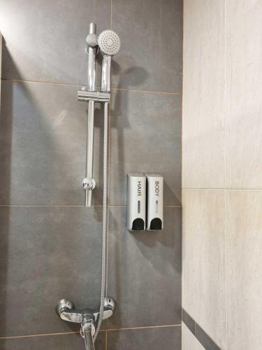 a shower in a bathroom with a shower head at EL RINCÓN DE SAN NICOLÁS in Soria