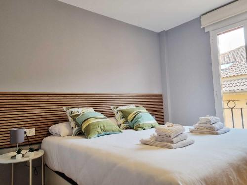 a bedroom with two beds and a window at EL RINCÓN DE SAN NICOLÁS in Soria