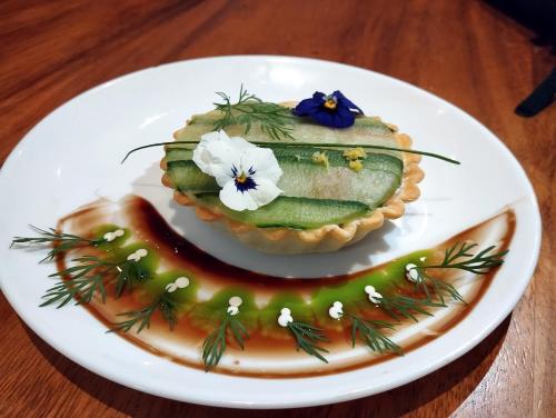 a plate with a cucumber pie on a table at La Pura Vida 34 in Pignan