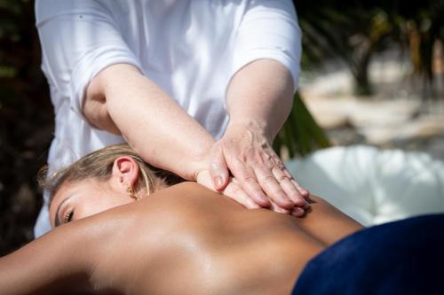 a woman getting a massage from a therapist at La Pura Vida 34 in Pignan