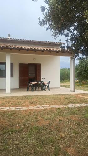 a patio of a house with a table and chairs at Agriturismo La tana della volpe in Alberese