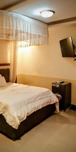 a bedroom with a bed and a window at Ltg Hotel Apartment in Juba