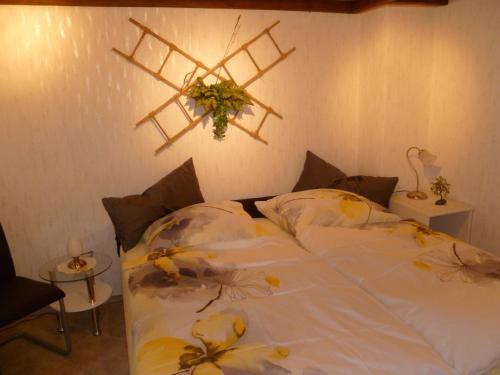 a bedroom with a white bed with flowers on it at Guest House Schneider in Laatzen