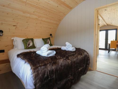 a bedroom with a bed with towel animals on it at Barn Owl in Carnforth