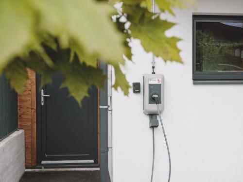 a pay phone next to a building with a door at First IN Mountain Chalets by we rent in Kaprun