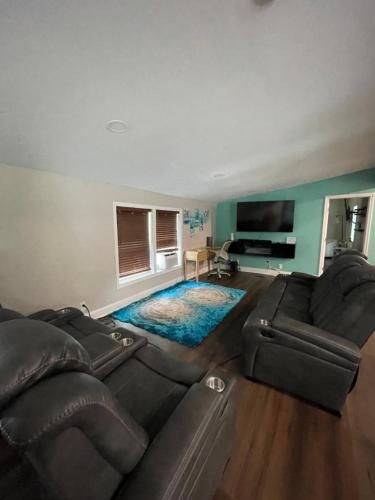 a living room with a couch and a flat screen tv at Serenity away from the big city in Amelia