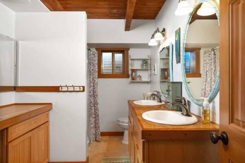 a bathroom with two sinks and a mirror at CherryView Lane in White Salmon