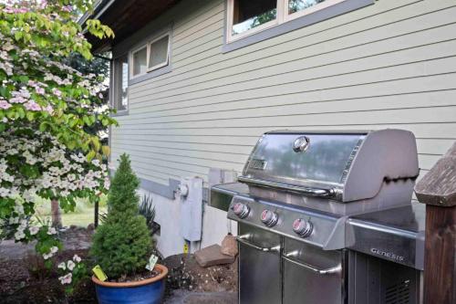 a grill sitting in a yard next to a house at CherryView Lane in White Salmon