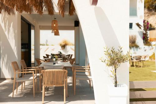 a restaurant with tables and chairs on a patio at Acron Suites in Limenaria