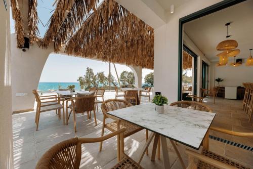 a dining room with a view of the ocean at Acron Suites in Limenaria