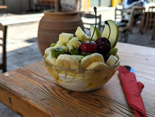 a bowl of fruits and vegetables on a table at ISSA Lesvos in Mytilini