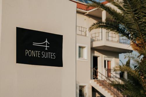 a sign on the side of a building at Ponte Suites in Antirrio
