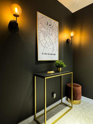 a black and gold table with a map on the wall at Apartament Cieszynka in Ciechanów