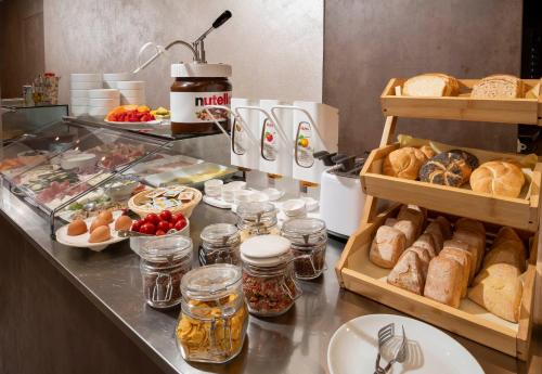 a breakfast buffet with bread and other foods on a counter at B&B Primrose Residence Hotel in Rimini